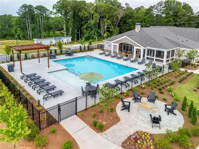 an aerial view of a house with swimming pool and patio