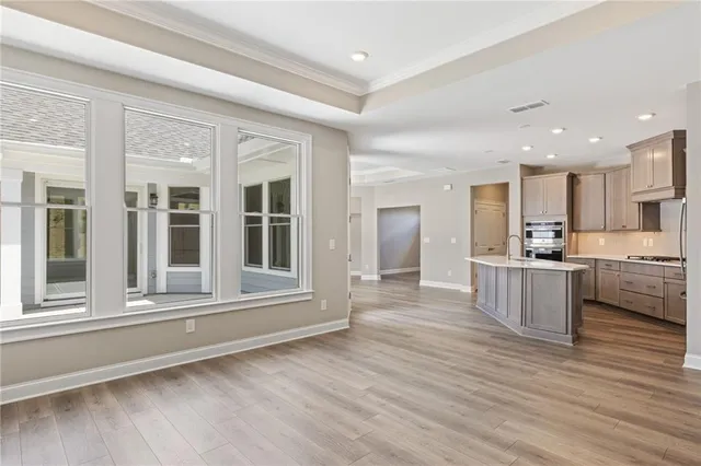 a view of kitchen with wooden floor and electronic appliances