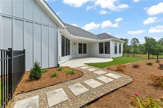 a view of a house with backyard and sitting area