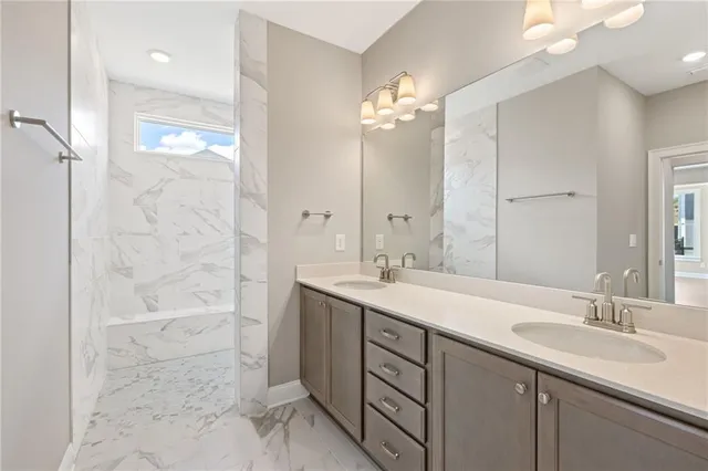 a bathroom with a double vanity sink mirror and shower