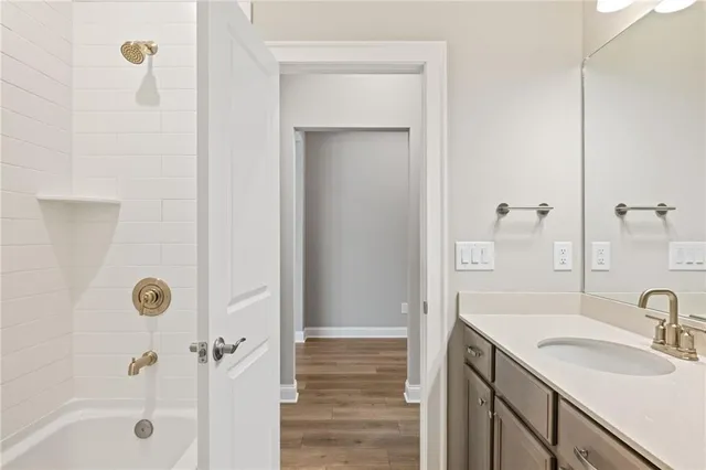 a bathroom with a sink a shower and a mirror