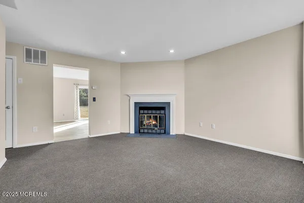 a view of an empty room with a fireplace