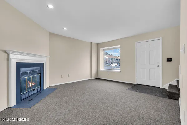 a view of an empty room with a fireplace