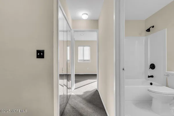 a bathroom with a granite countertop sink a toilet and shower