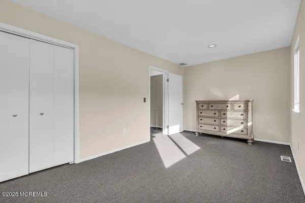 a view of an empty room with a cabinet