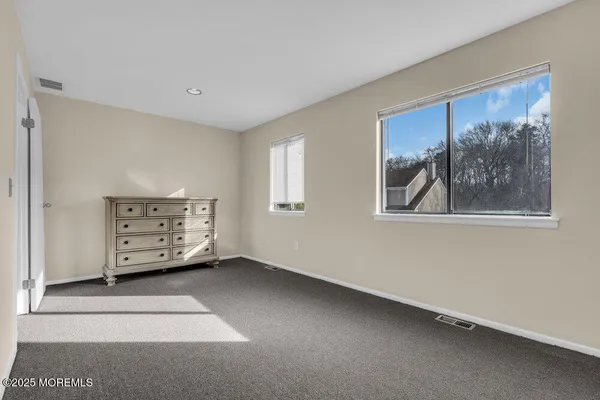 a view of an empty room with closet