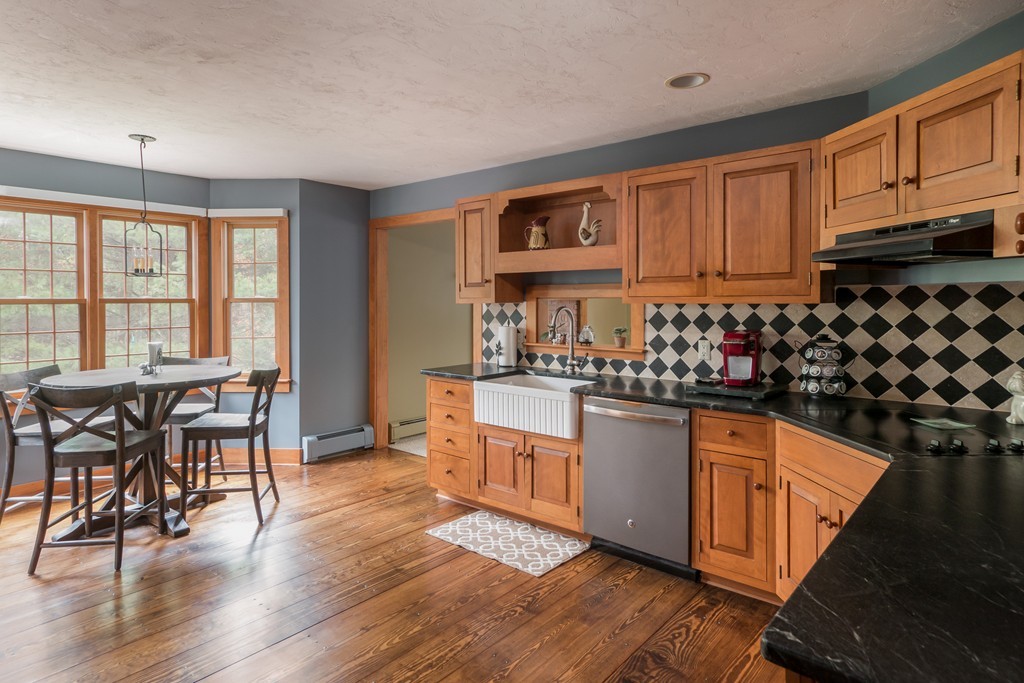 32 Blanchard Road Grafton, MA 01519 - Photo 11 of 30 a kitchen with stainless steel appliances granite countertop a stove and white cabinets