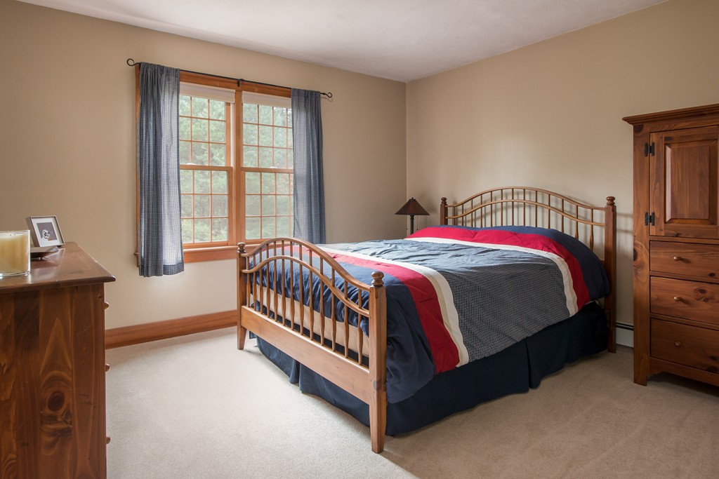 32 Blanchard Road Grafton, MA 01519 - Photo 19 of 30 a bed sitting in a bedroom next to a window