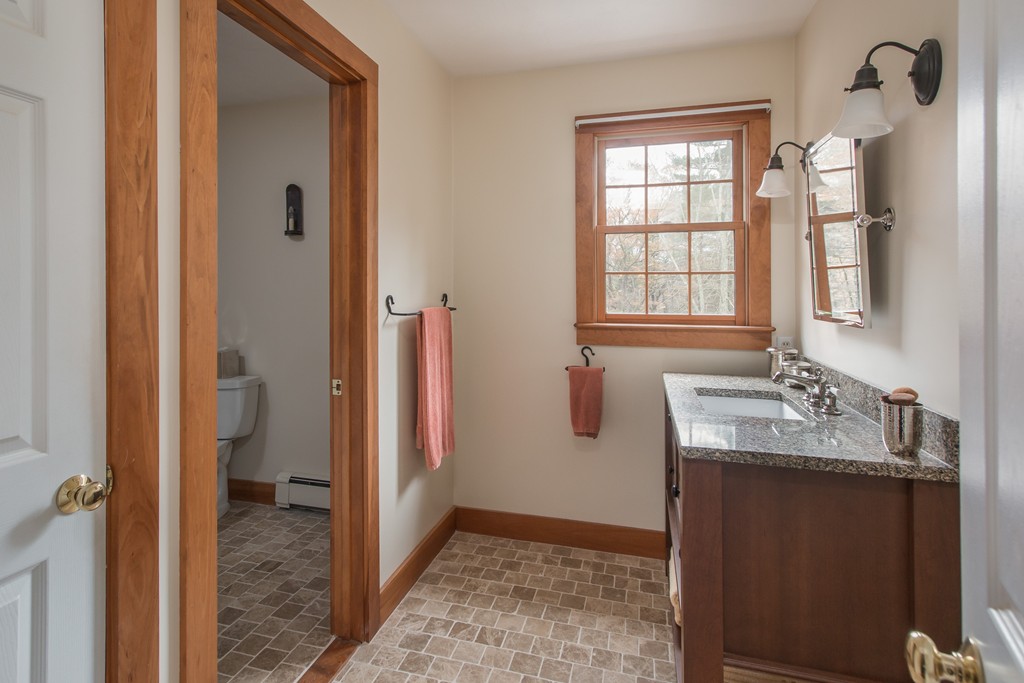 32 Blanchard Road Grafton, MA 01519 - Photo 26 of 30 a bathroom with a granite countertop sink and a window
