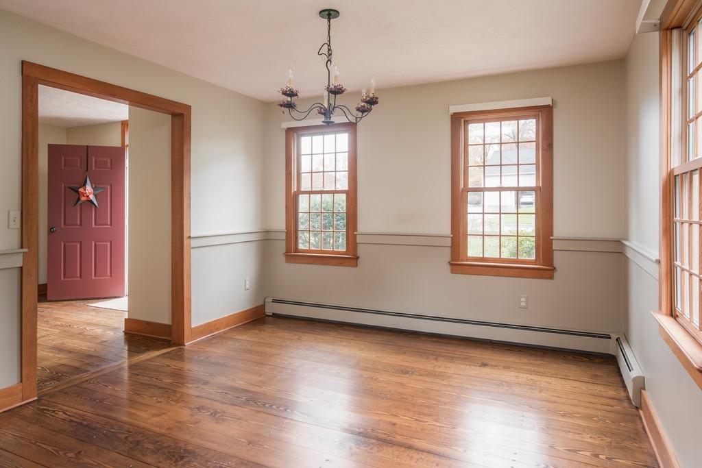 32 Blanchard Road Grafton, MA 01519 - Photo 9 of 30 an empty room with wooden floor chandelier and windows