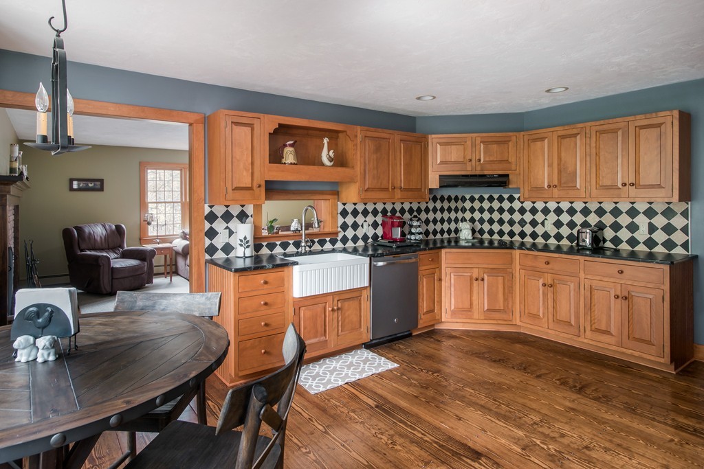 32 Blanchard Road Grafton, MA 01519 - Photo 10 of 30 a kitchen with stainless steel appliances granite countertop a stove a sink dishwasher a dining table and chairs with wooden floor