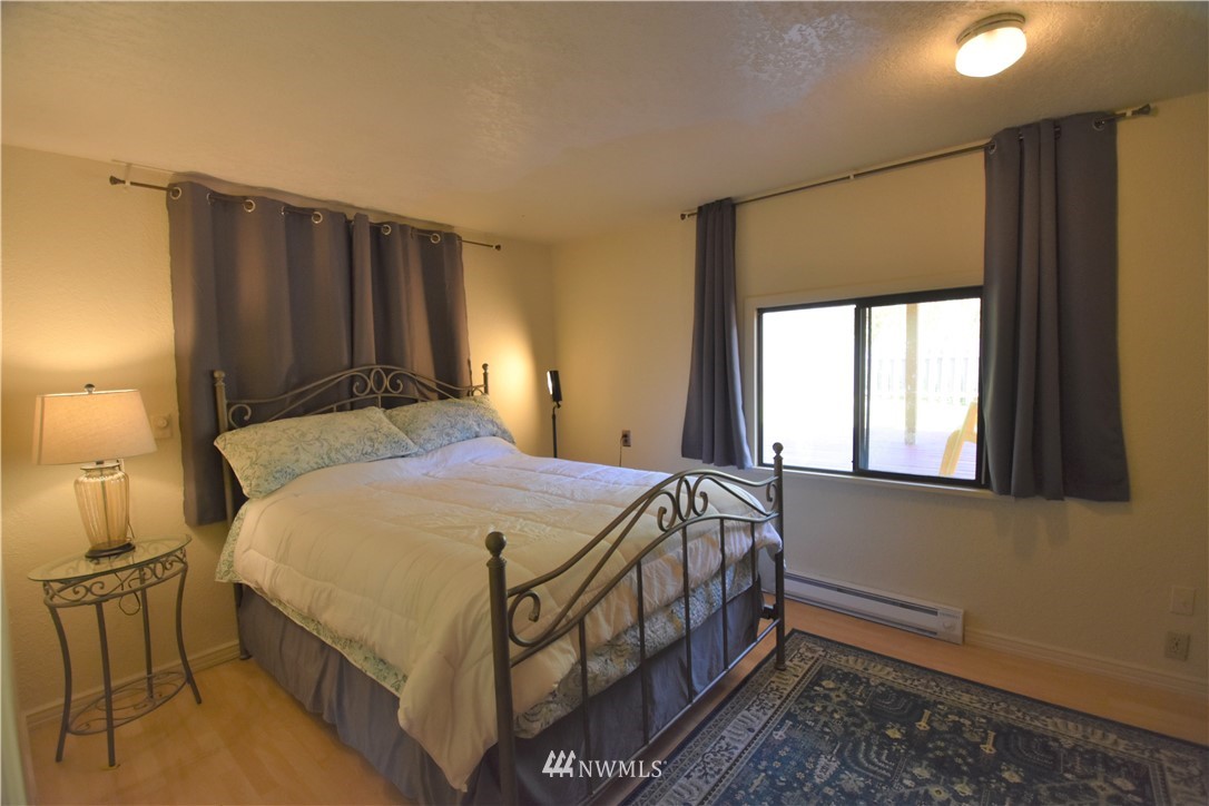 2409 Callow Road Lake Stevens, WA 98258 - Photo 11 of 16 a bedroom with a bed table and a window