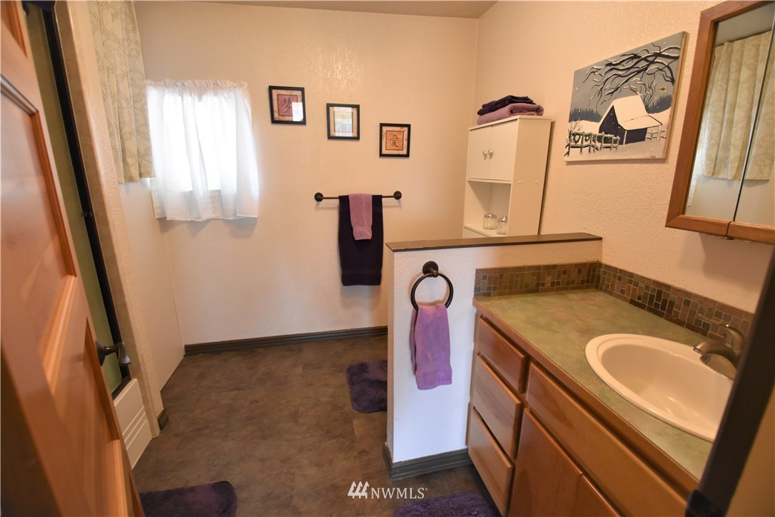 2409 Callow Road Lake Stevens, WA 98258 - Photo 12 of 16 a bathroom with a granite countertop sink and a mirror