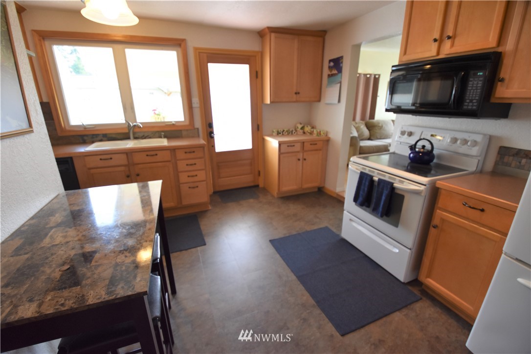 2409 Callow Road Lake Stevens, WA 98258 - Photo 9 of 16 a kitchen with a sink a stove and microwave