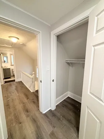 a view of a big room with wooden floor and a bathroom