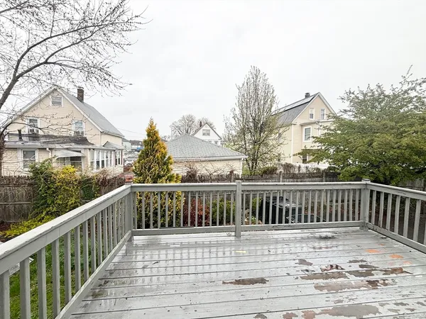 a view of a balcony with wooden fence and floor