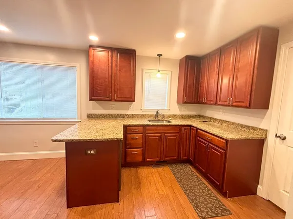 a kitchen with stainless steel appliances granite countertop wooden cabinets a sink and dishwasher