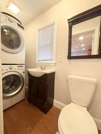 a bathroom with a toilet a sink and a mirror
