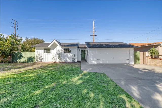 a view of a house with a yard and garage