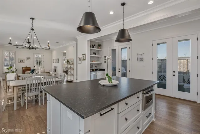 a kitchen with stainless steel appliances granite countertop a sink a refrigerator and a table