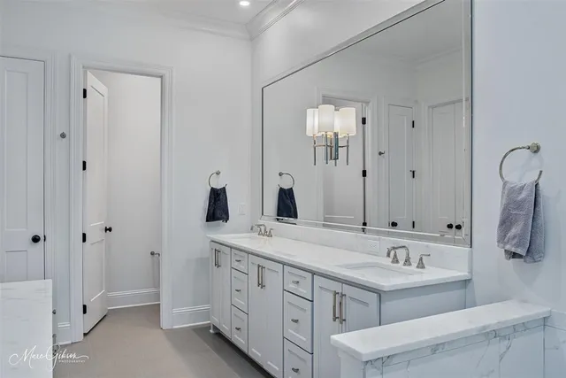 a bathroom with a double vanity sink and a mirror