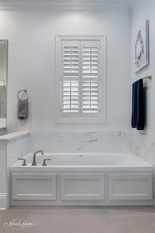 a bathroom with bathtub and window