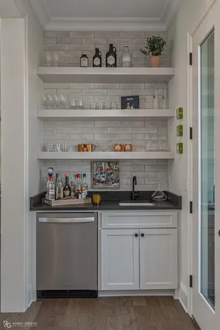 a kitchen with white cabinets and a wooden floor