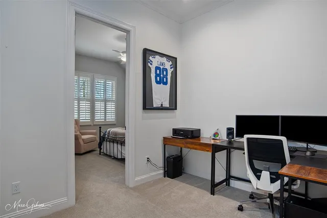 a view of a workspace with furniture and a window