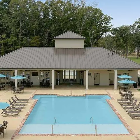 an outdoor space with lots of furniture and barbeque oven