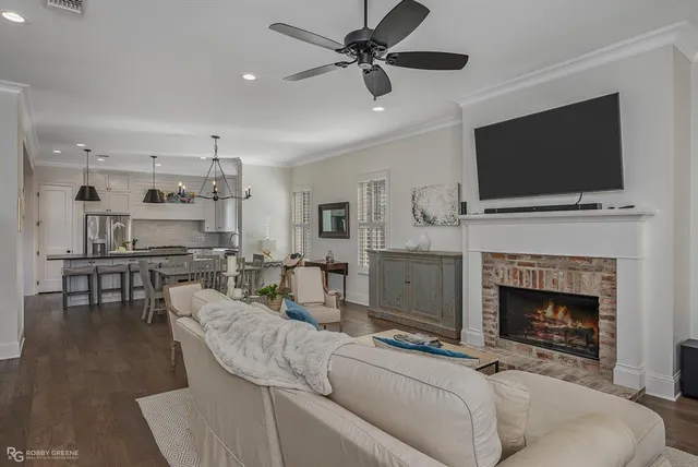 a living room with furniture a flat screen tv and a fireplace