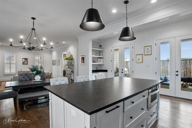 an open kitchen with sink table and chairs