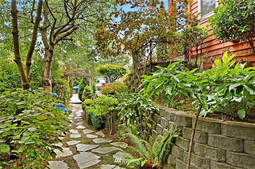 308 North 133rd Street Seattle, WA 98133 - Photo 16 of 18 a backyard of a house with lots of green space and a fountain