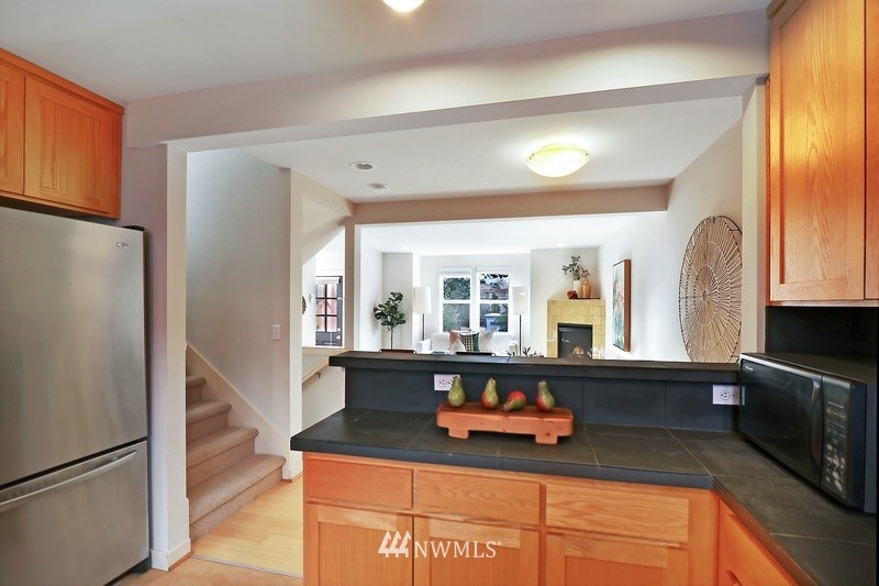308 North 133rd Street Seattle, WA 98133 - Photo 7 of 18 a kitchen with granite countertop a refrigerator and a sink