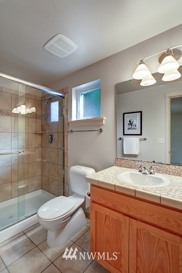 308 North 133rd Street Seattle, WA 98133 - Photo 8 of 18 a bathroom with a sink a toilet and shower