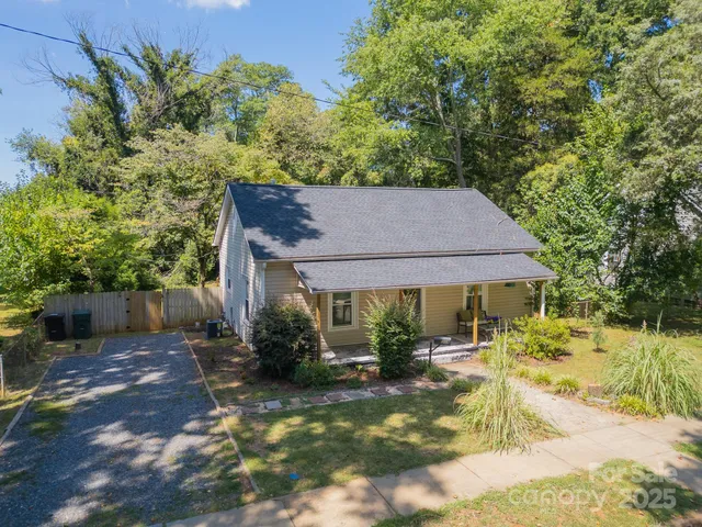 a backyard of a house with yard and outdoor seating