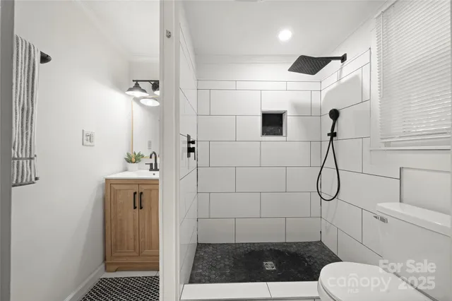 a bathroom with a shower a toilet and a sink