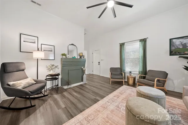 a living room with furniture and a wooden floor
