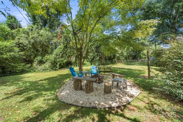 a view of a house with a yard and sitting area