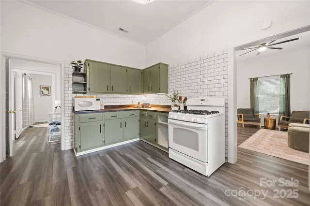 a kitchen with a stove a sink and a refrigerator