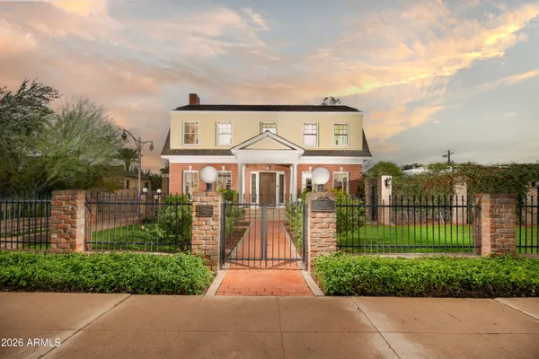 a front view of a house with a garden and pathway