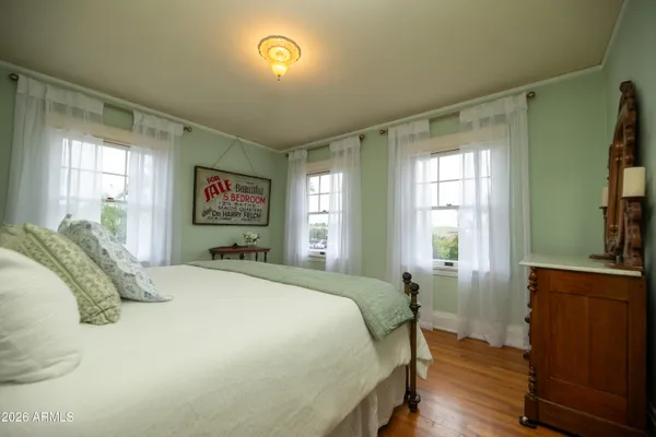 a front view of a house with a tree