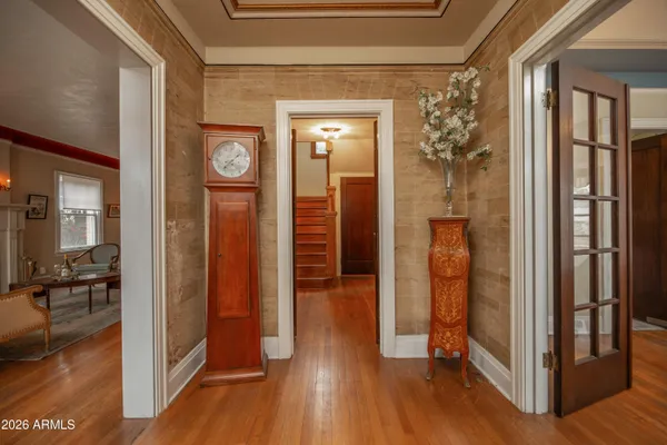 a living room with furniture fireplace and wooden floor