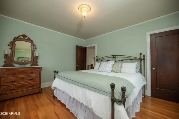 an empty room with wooden floor and mirror