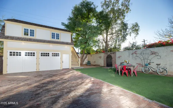 a view of a patio with table and chairs with wooden floor and fence