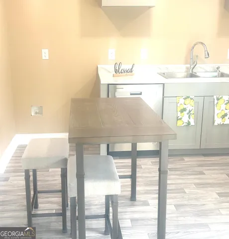 a kitchen with granite countertop a sink stove and cabinets