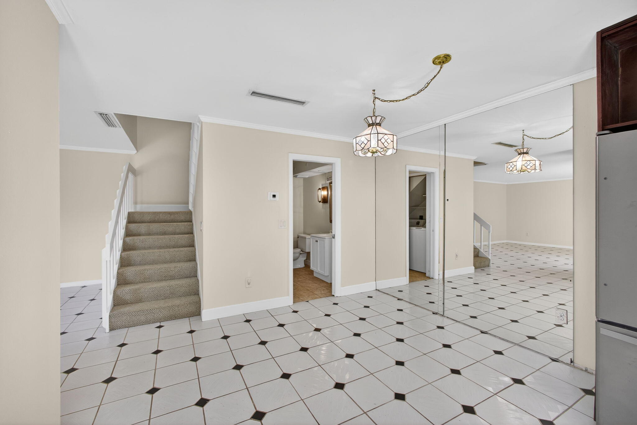 825 Center Street, Unit 9A Jupiter, FL 33458 - Photo 15 of 52 a view of a hallway with chandelier and wooden floor