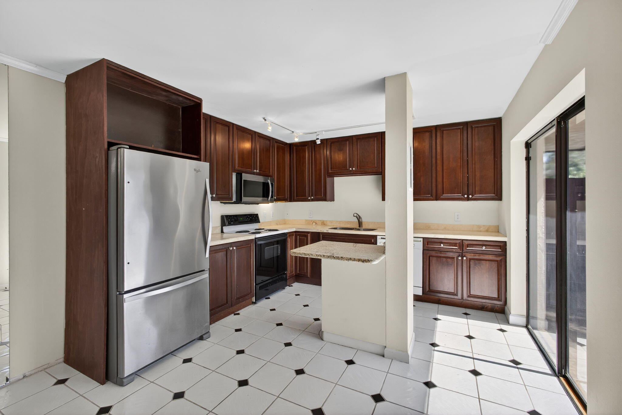 825 Center Street, Unit 9A Jupiter, FL 33458 - Photo 19 of 52 a kitchen with stainless steel appliances a refrigerator sink and cabinets