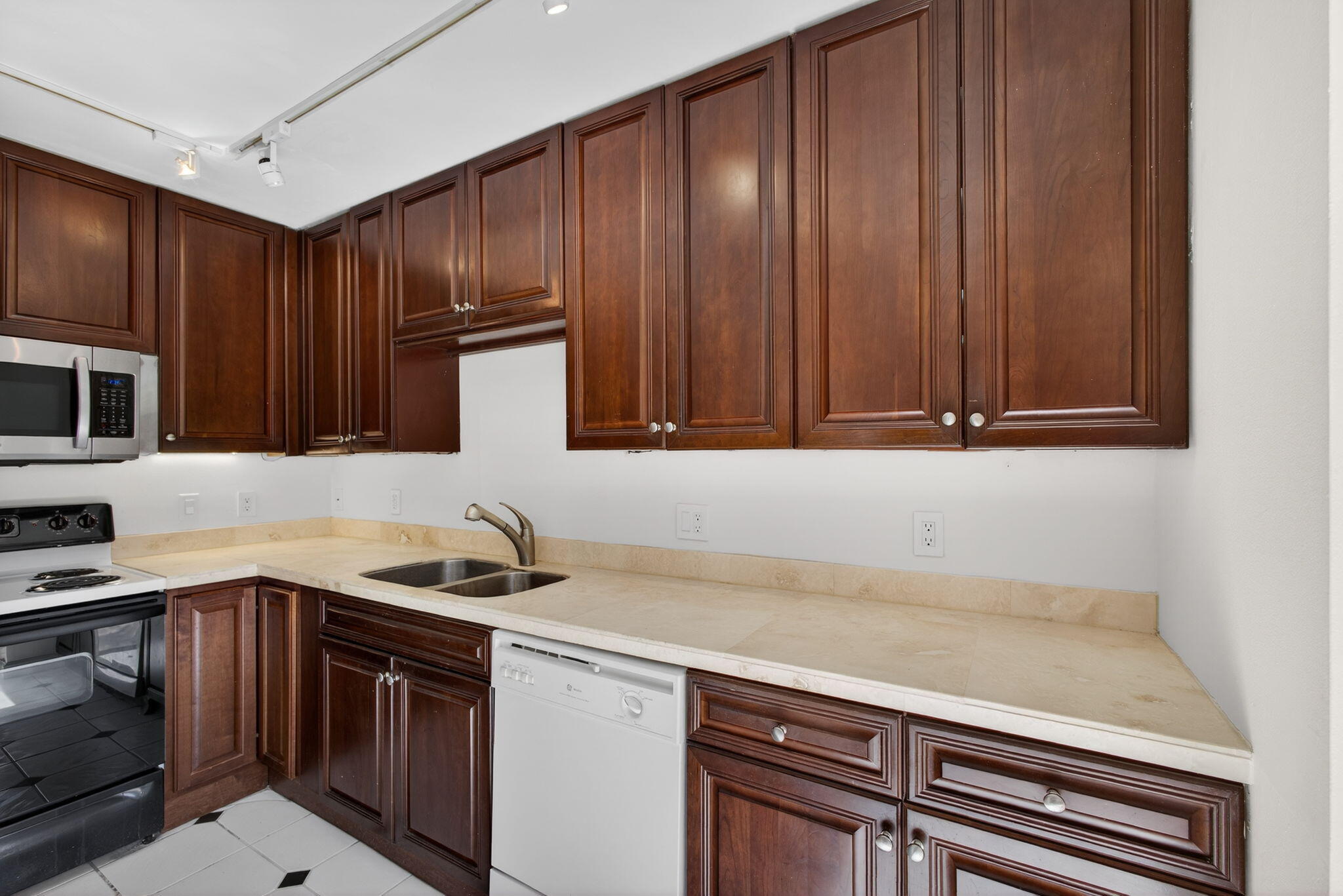 825 Center Street, Unit 9A Jupiter, FL 33458 - Photo 20 of 52 a kitchen with stainless steel appliances granite countertop a sink stove and cabinets