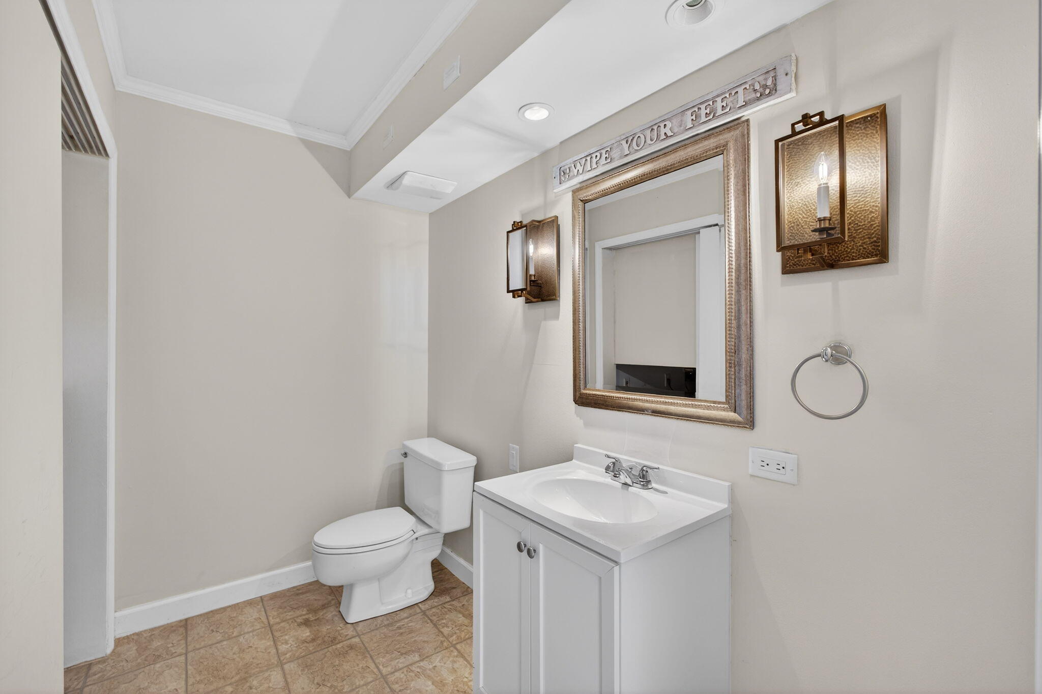 825 Center Street, Unit 9A Jupiter, FL 33458 - Photo 24 of 52 a bathroom with a toilet sink and mirror