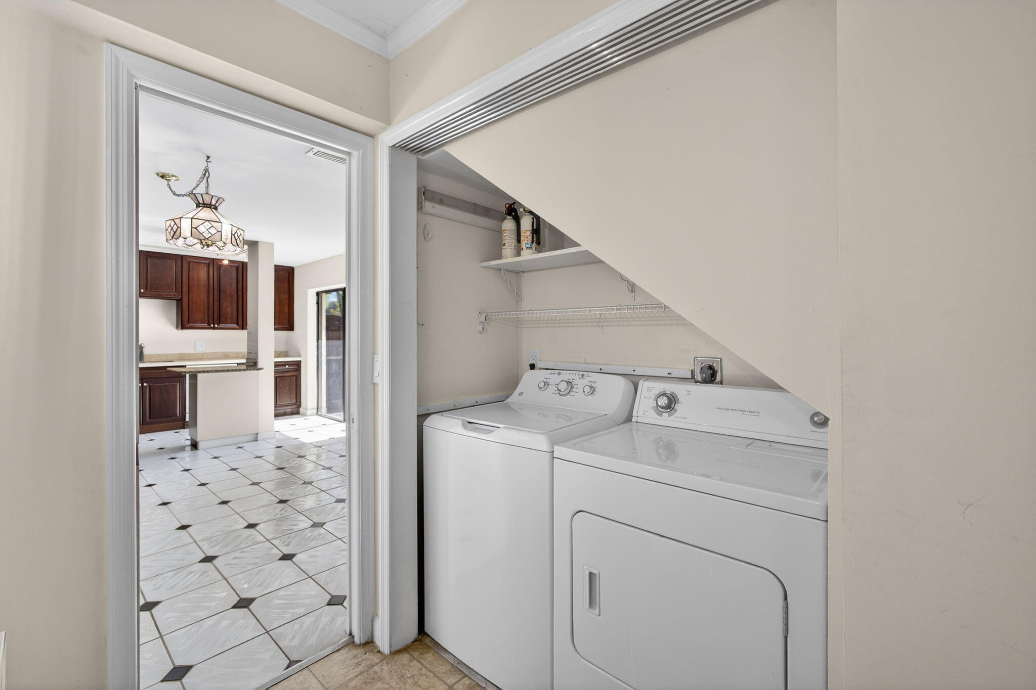 825 Center Street, Unit 9A Jupiter, FL 33458 - Photo 25 of 52 a view of washer and dryer with kitchen in the background